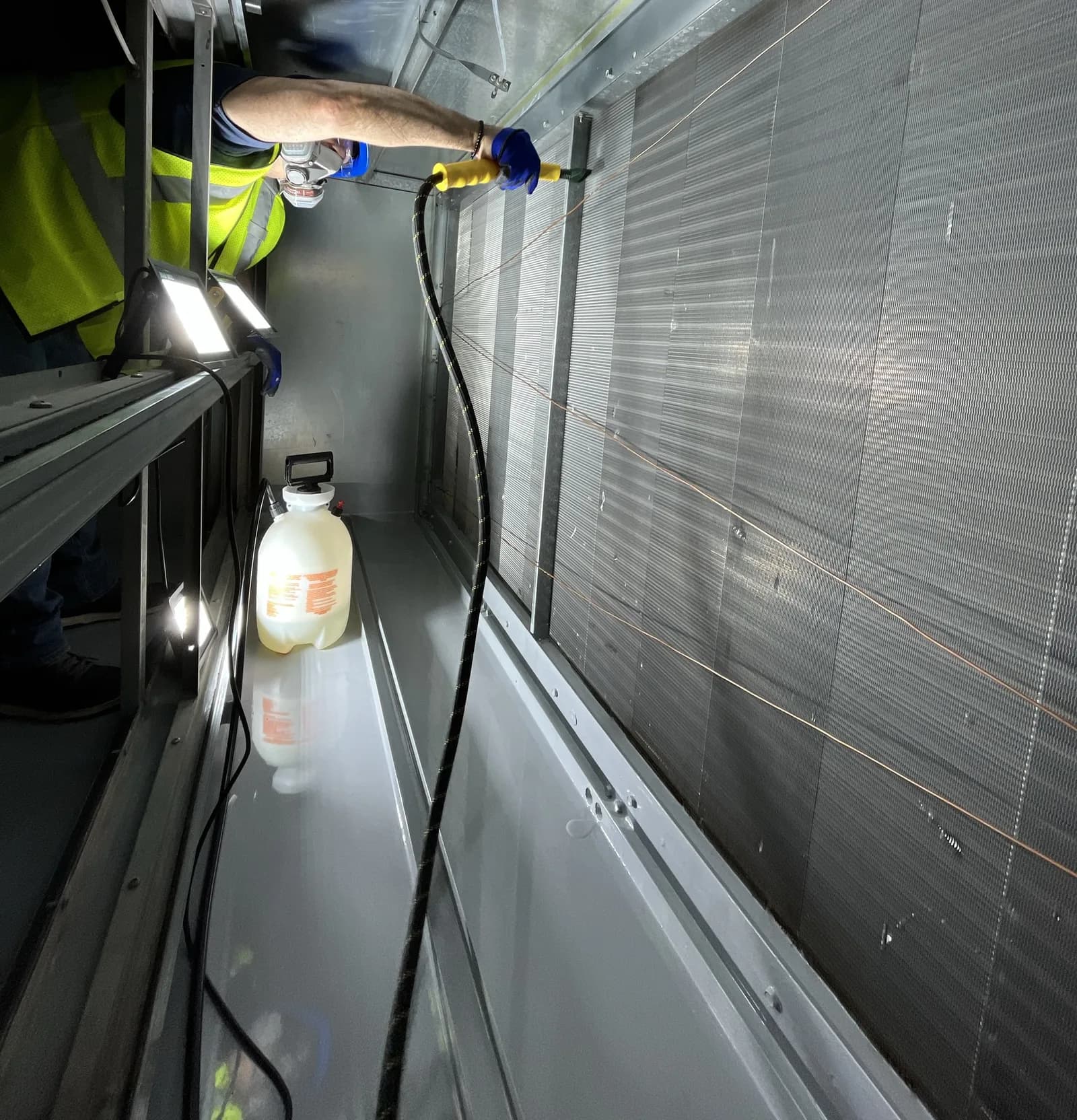 Urbacons technician deep-cleaning a cooling coil