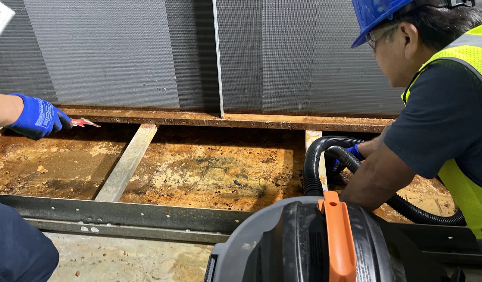 Urbacons technician preparing a deteriorated drain pan surface