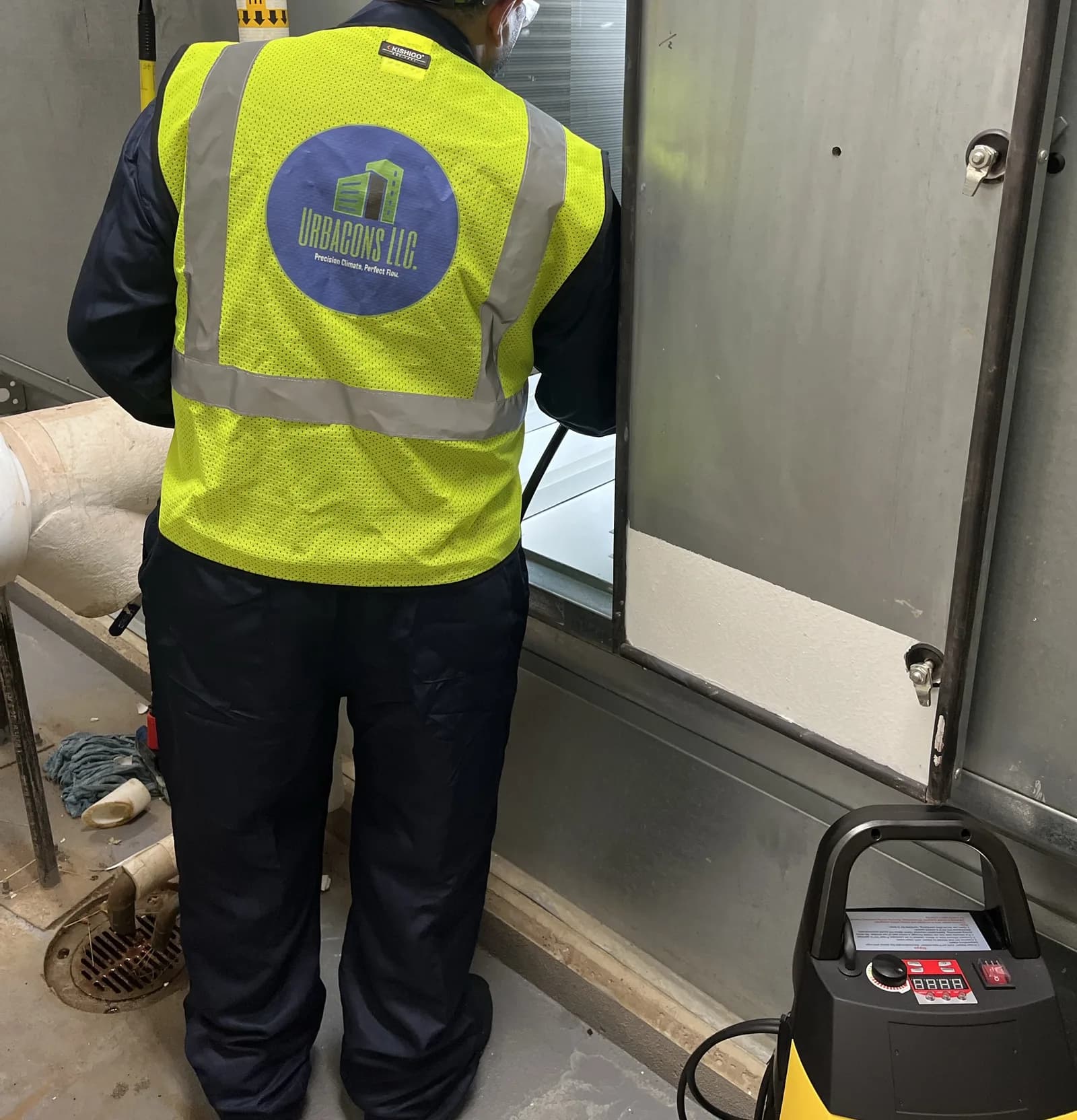 Urbacons technician accessing an air handling unit for condition assessment